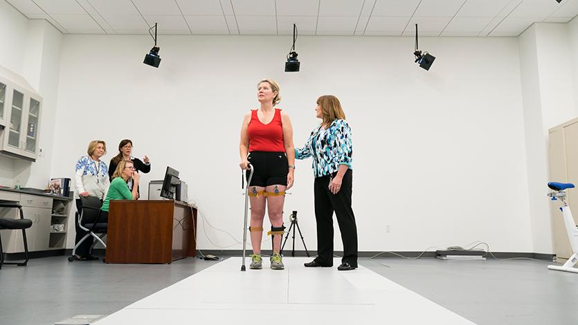 Doctor of Physical Therapy Program faculty work with a patient.