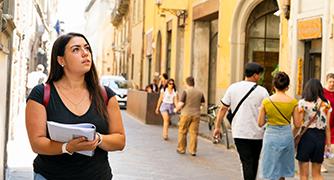 Student walking and writing in Italy