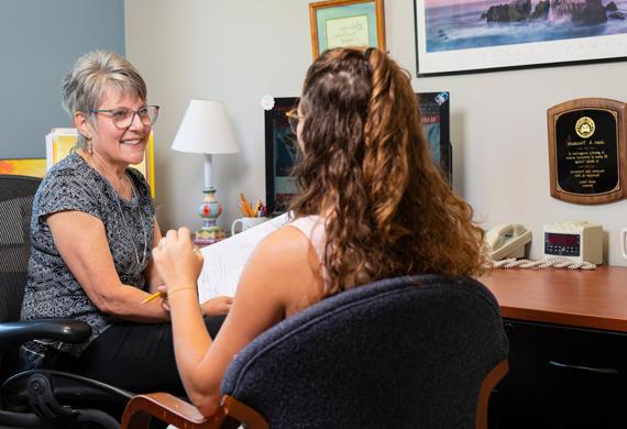 Image of faculty member meeting with a student.