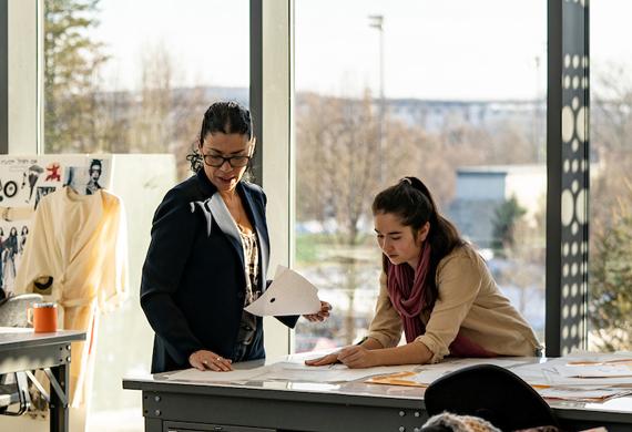 Image of student working with faculty member in senior fashion lab.