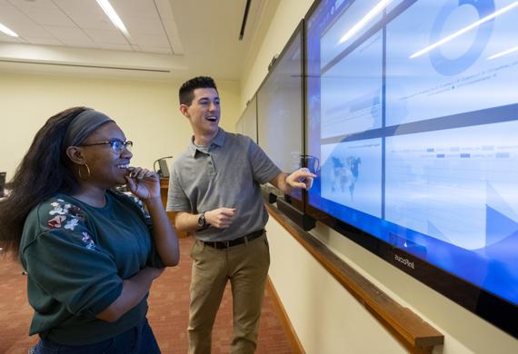 Image of students collaborating in a computer lab