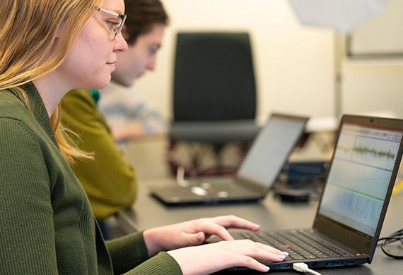 Image of a students on computers monitoring brain activity.