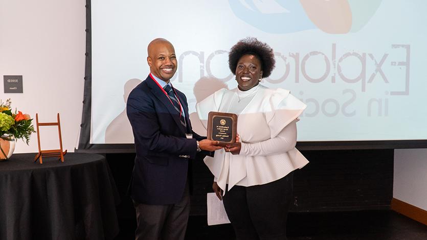 Image of Kumba Nyang accepting the social justice award.