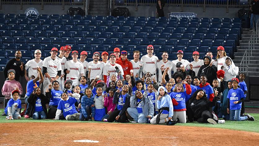 Image of baseball team with members of the Boys & Girls club.