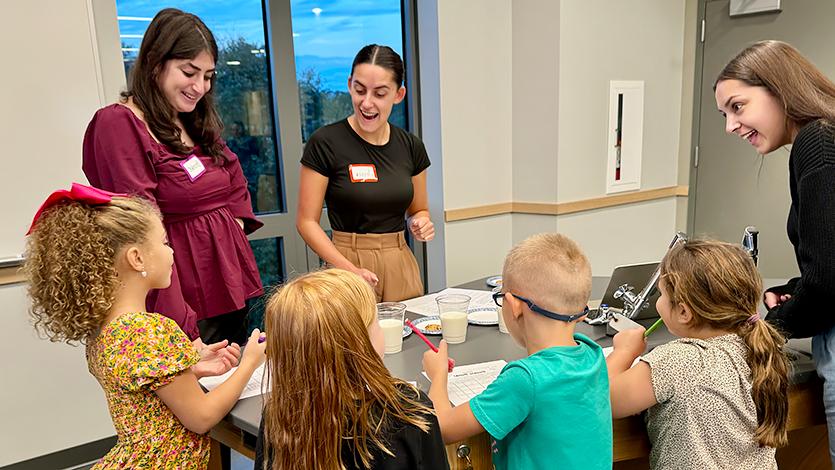 Image of Teacher Candidates Brooke Fanuele '25, Danielle Lipof '25, Jessica Goetchius '25 in the Teaching Methods lab on Marist STEM Night. 