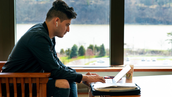 Image of a student studying in the library.